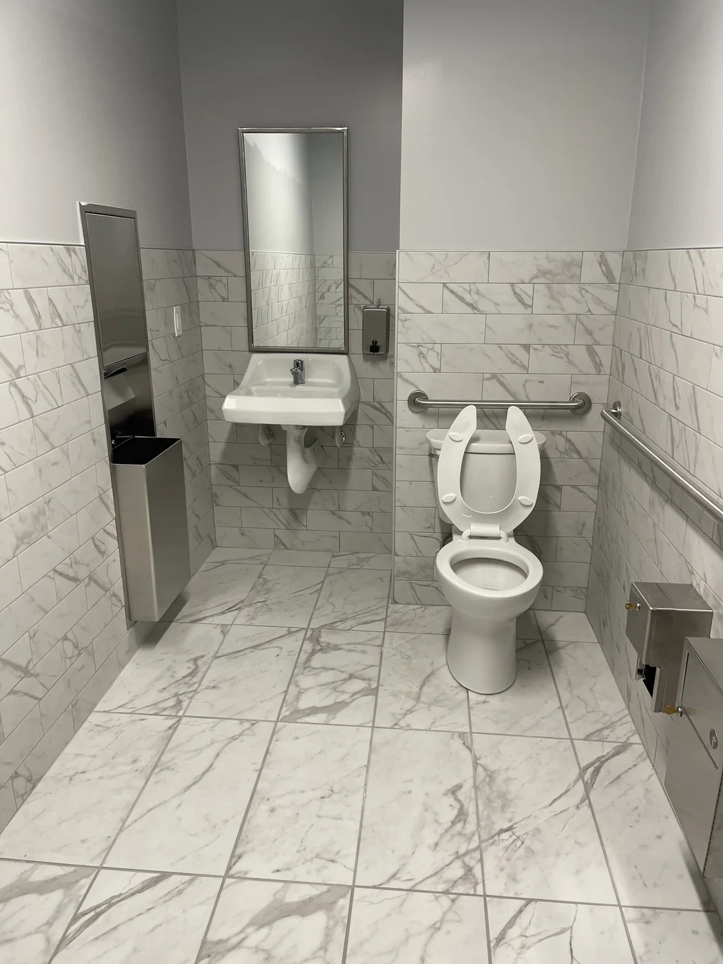 Finished commercial restroom with multiple sinks